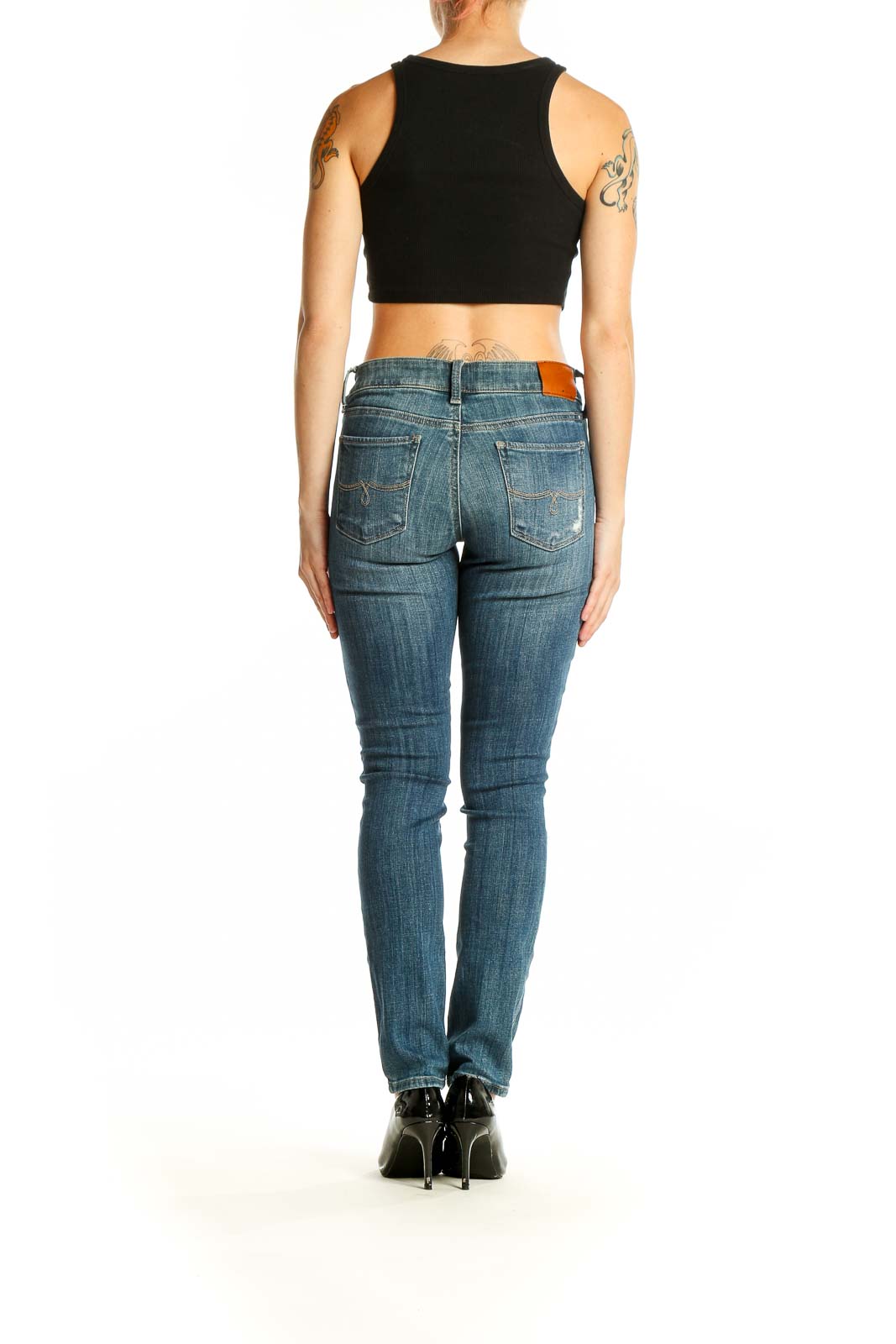 Back view of Lucky Brand blue distressed skinny jeans on model