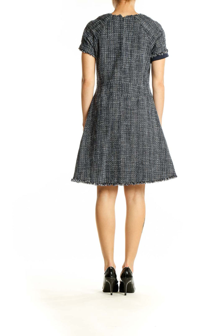 Side view of Banana Republic gray tweed A-line dress showing knee-length cut and frayed edges