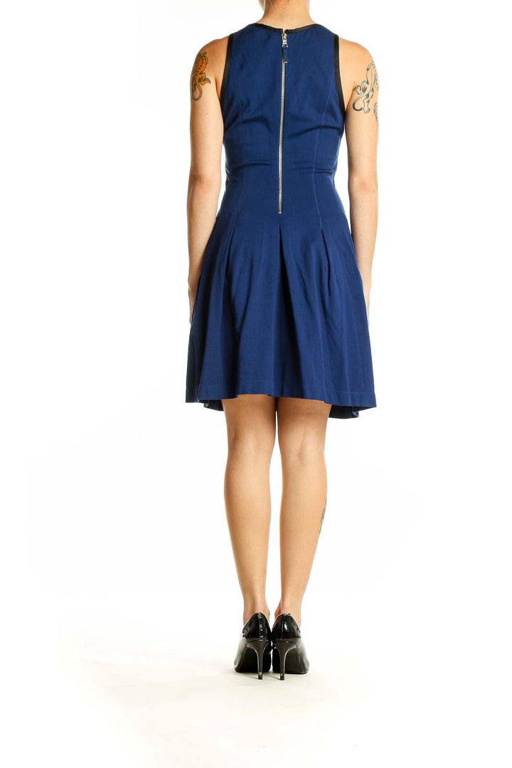 Side view of Banana Republic navy fit-and-flare sleeveless dress showing pleated skirt detail