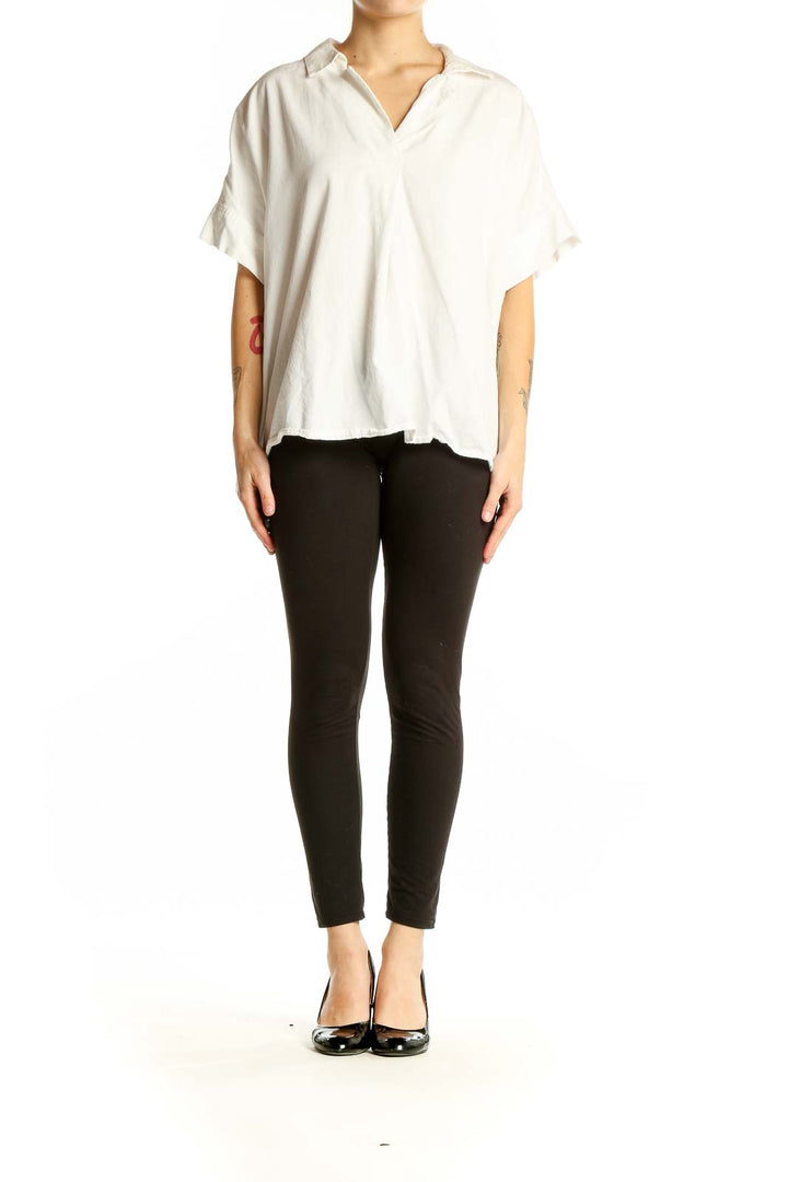 Front view of white oversized Madewell top with v-neck and short sleeves