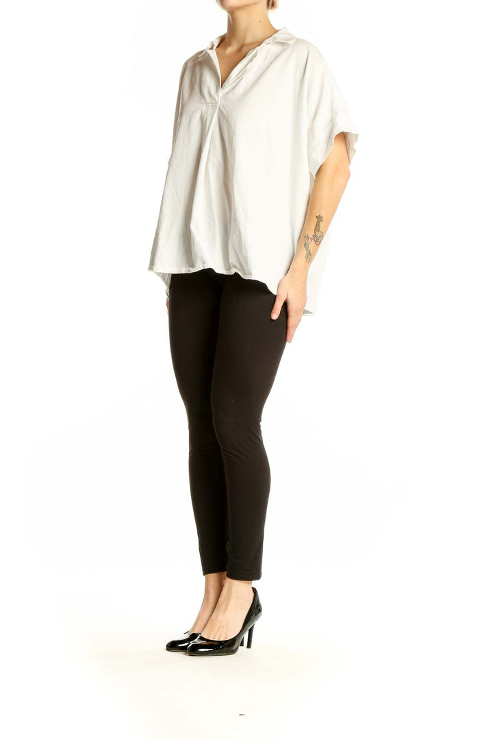 Front view of white oversized Madewell top with v-neck and short sleeves