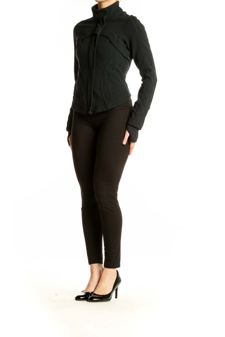 Front view of black Lululemon fitted activewear jacket with high collar