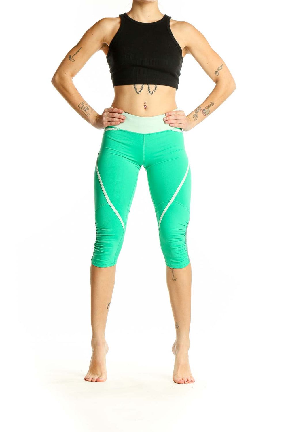 Front view of green Lululemon capri leggings with white stripes