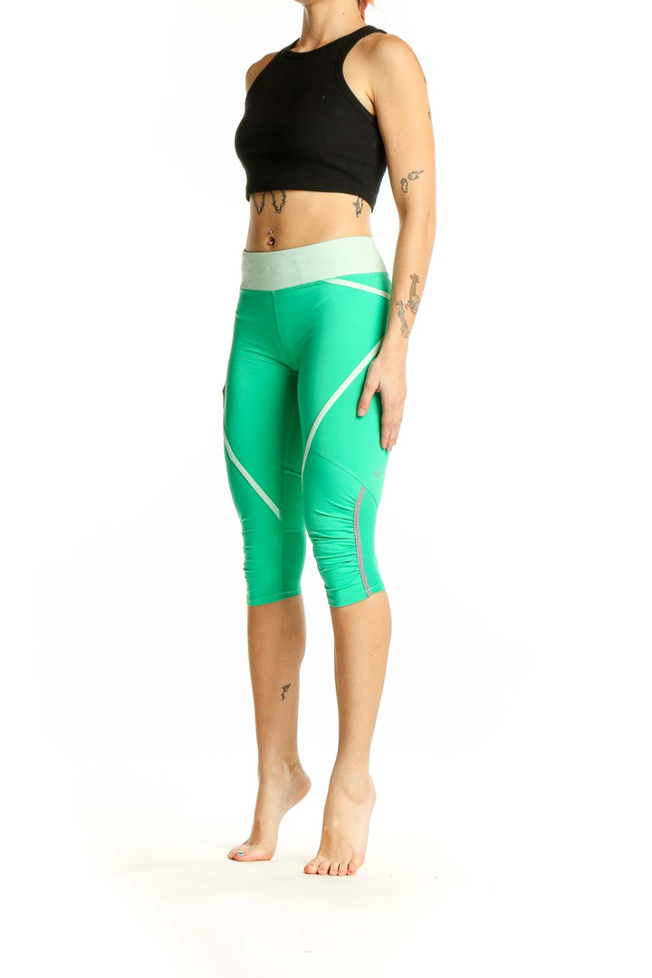 Front view of green Lululemon capri leggings with white stripes