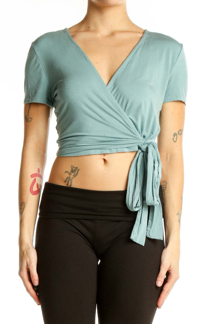 Front view of Miou Muse sage green wrap crop top with V-neck and tie waist