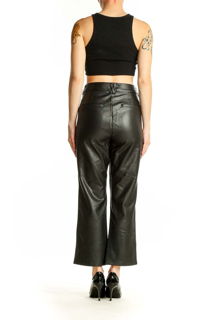 Side view of model wearing Maeve black faux leather wide-leg cropped pants