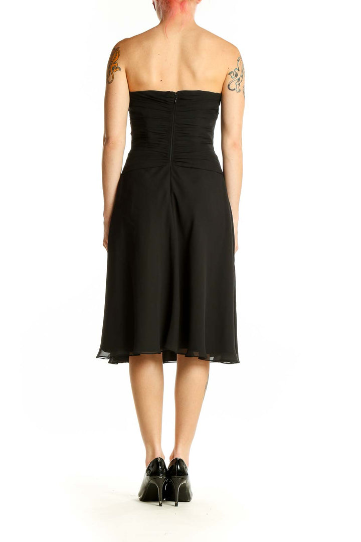 Side view of black strapless ruched cocktail dress from White House Black Market