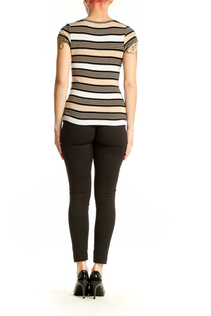 Side view of woman wearing beige striped cap sleeve top from The Limited