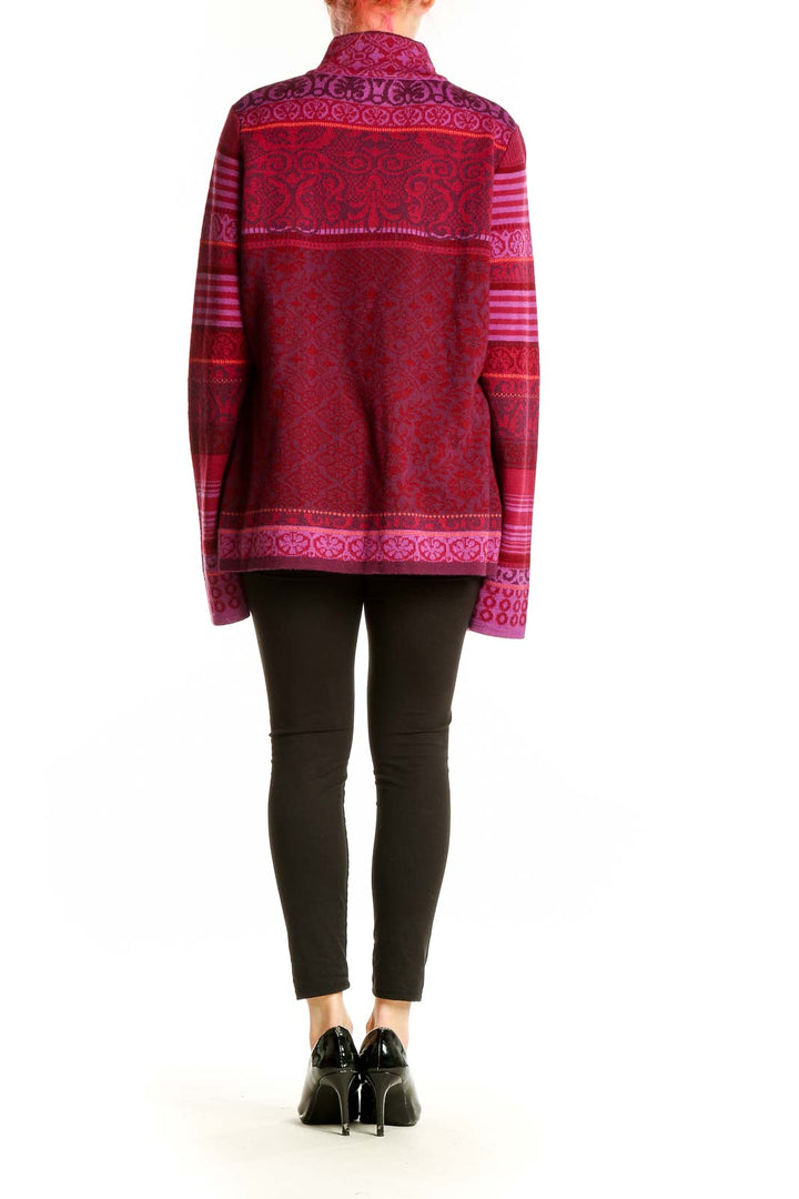 Back view of red patterned Icelandic Design zip-up sweater on model