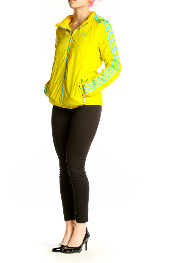 Front view of yellow Adidas athletic jacket with turquoise stripes