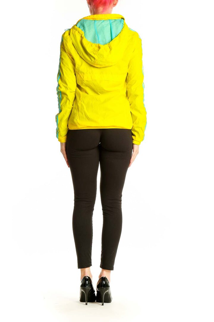 Back view of yellow Adidas athletic jacket with turquoise stripes