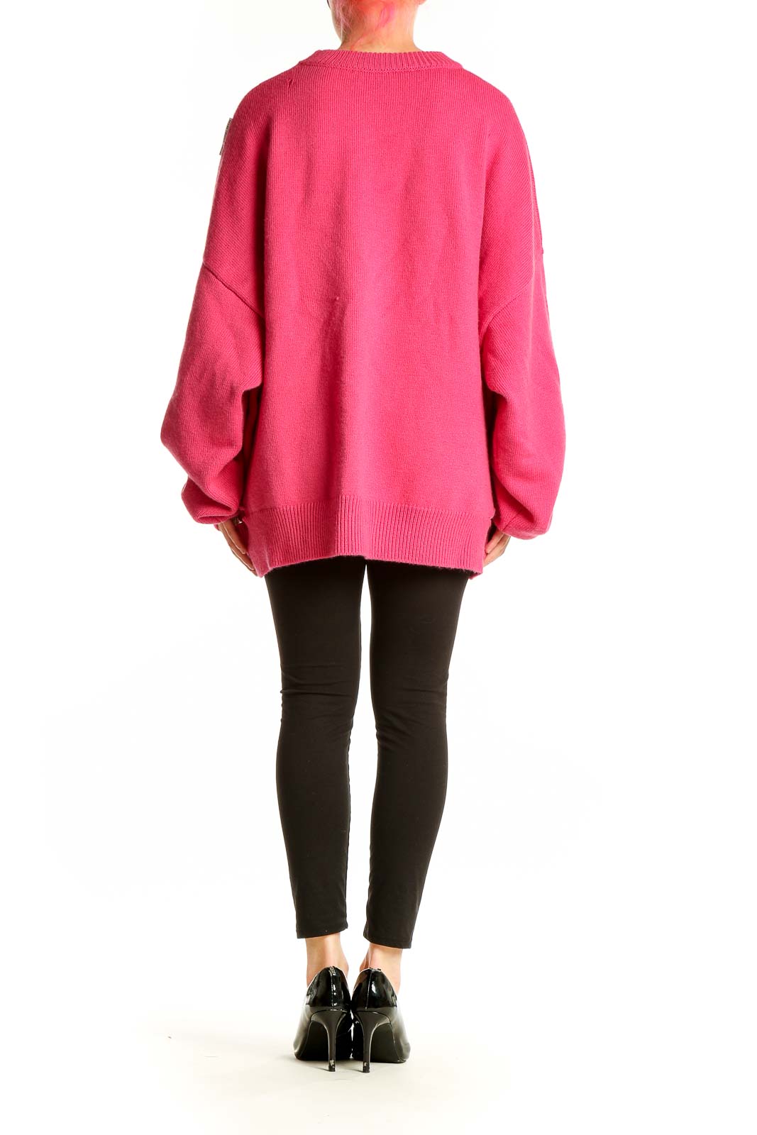 Side view of hot pink oversized distressed knit sweater by Ann Andelman on model
