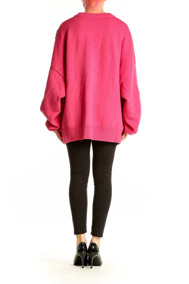 Side view of hot pink oversized distressed knit sweater by Ann Andelman on model