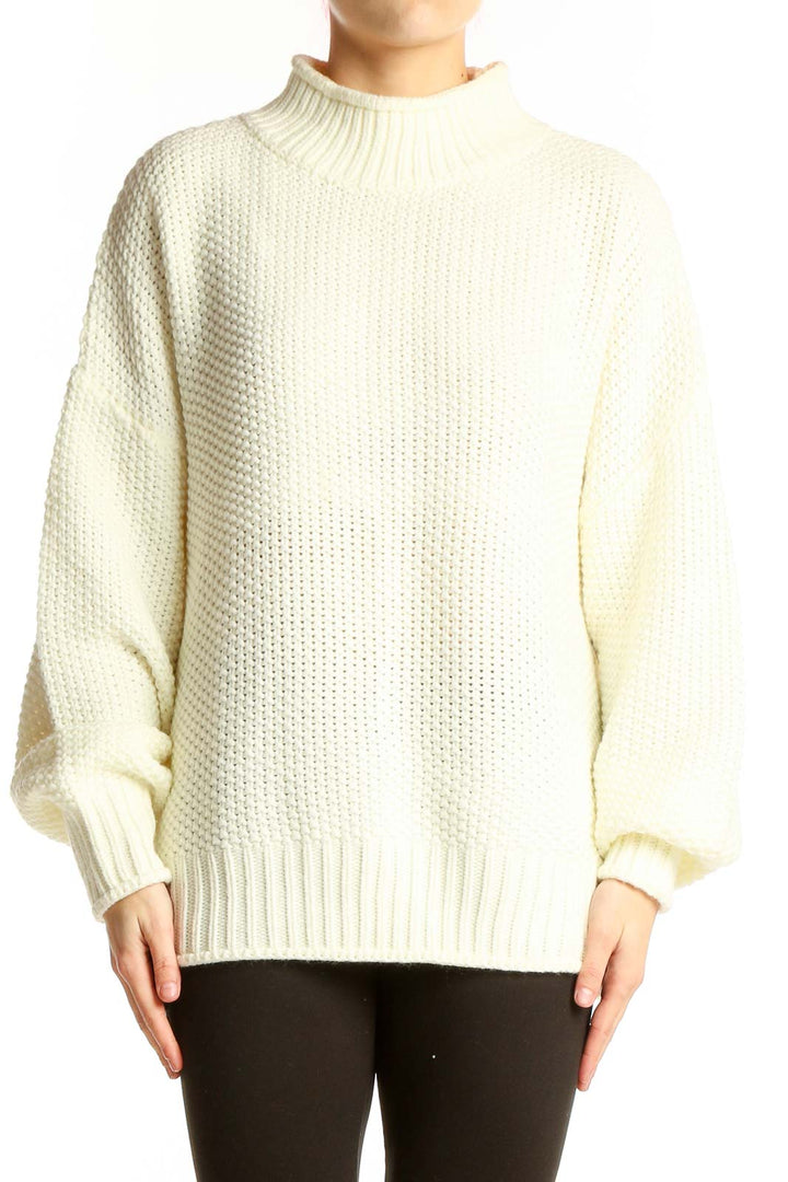 Front view of cream chunky knit mock neck sweater with balloon sleeves