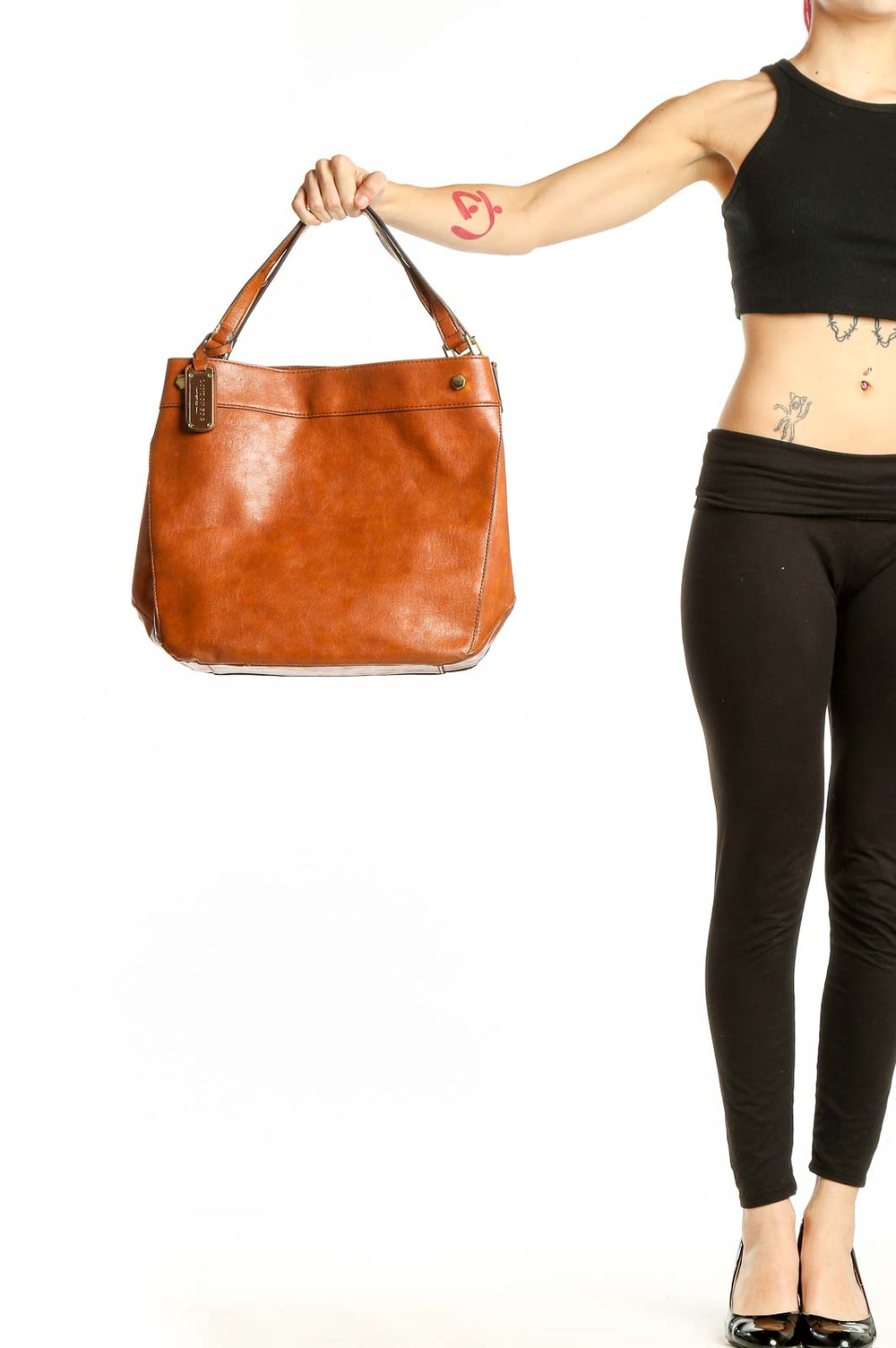 Front view of tan London Fog leather tote bag held by model's hand