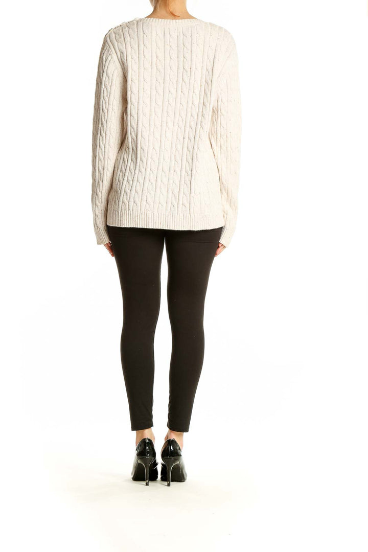 Full body view of model wearing Croft & Barrow cream cable knit sweater with black pants
