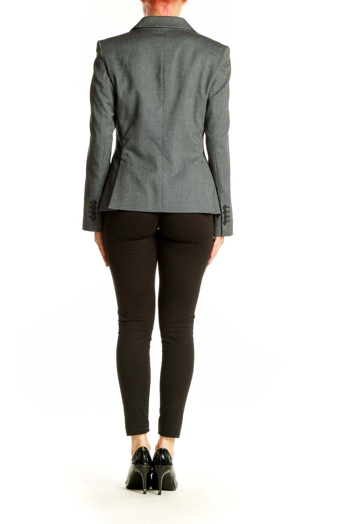 Side view of gray Express single-button blazer on model with black pants