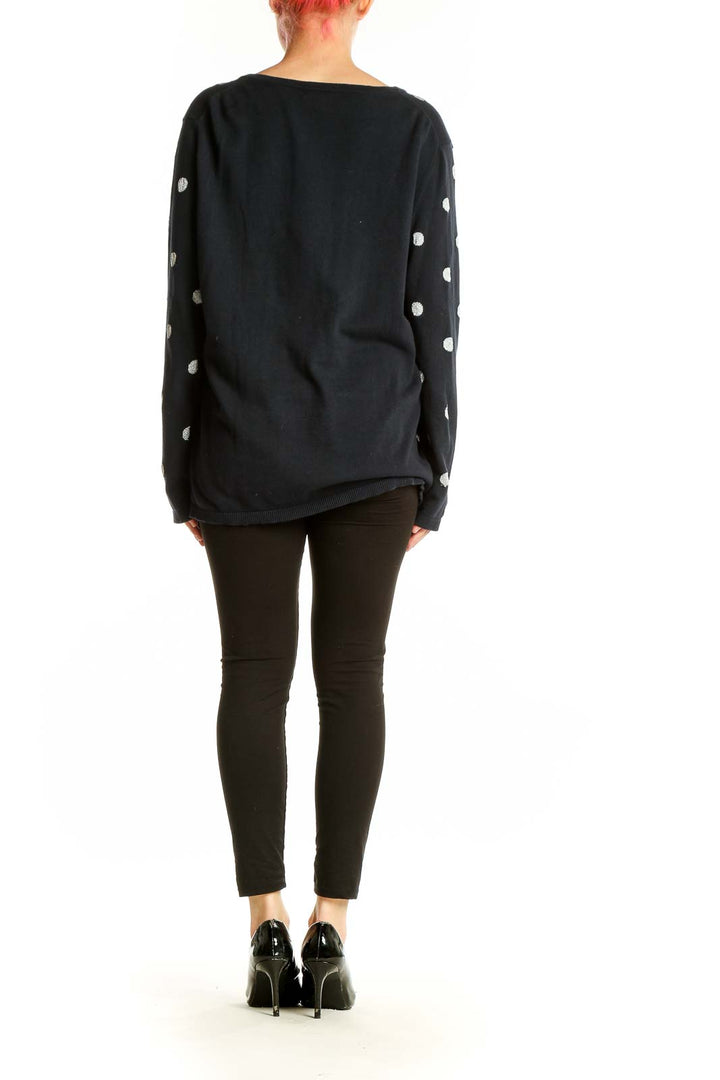 Side view of model wearing Tommy Hilfiger black polka dot V-neck sweater