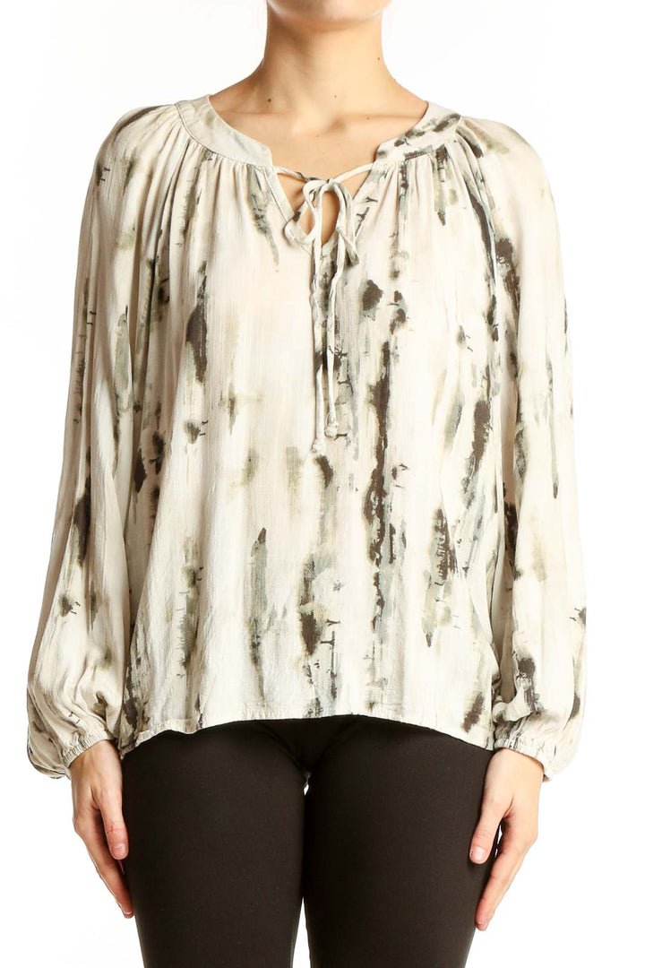 Front view of cream abstract print peasant blouse with tie neckline