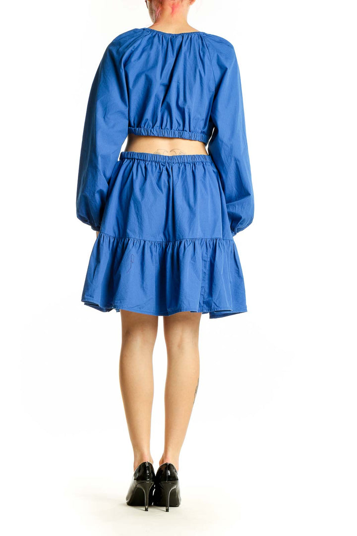 Side view of Gap blue cotton midi dress showing ruffle hem and cut-out detail