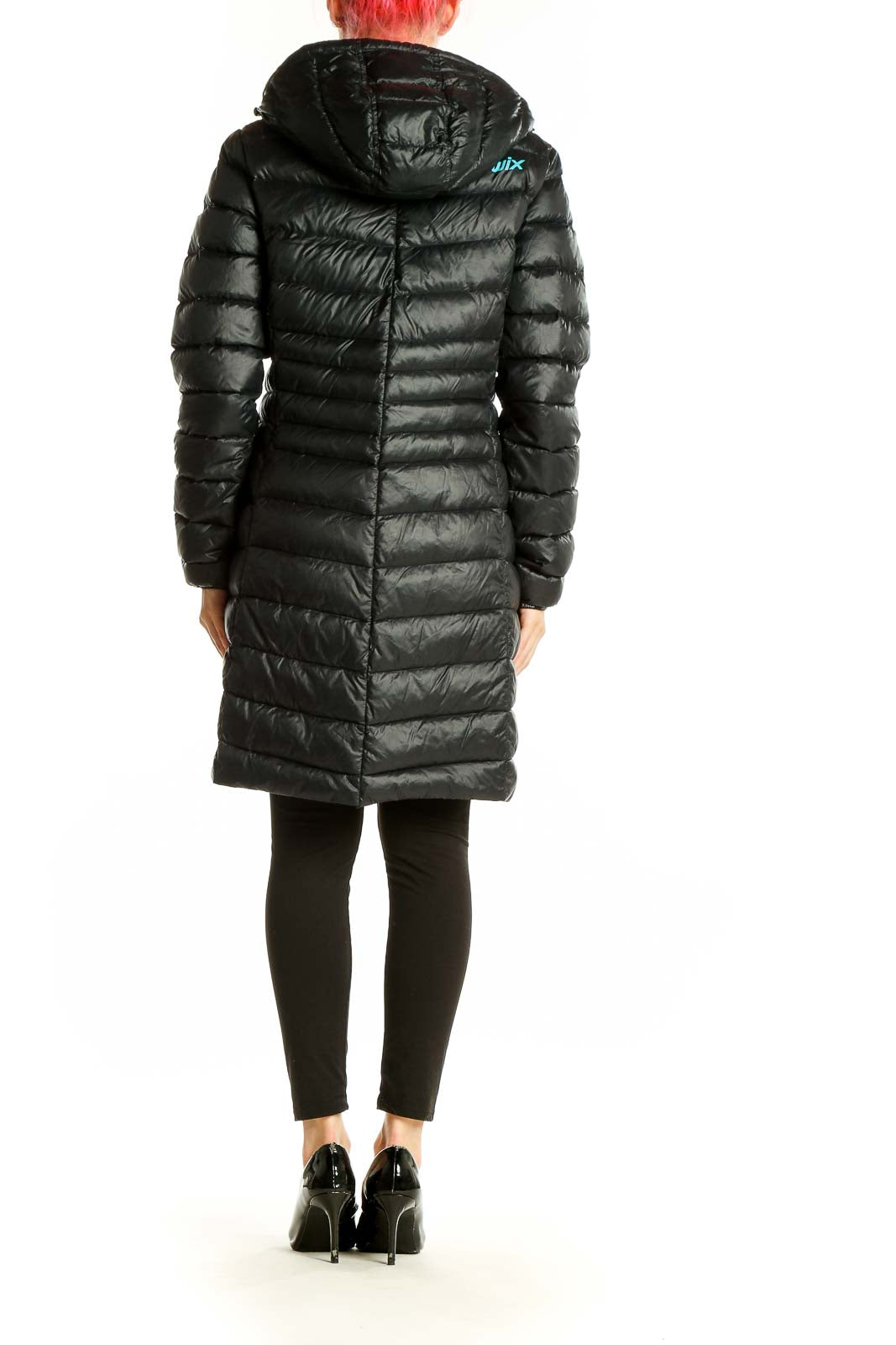 Side view of black Swix long puffer jacket showing quilted design