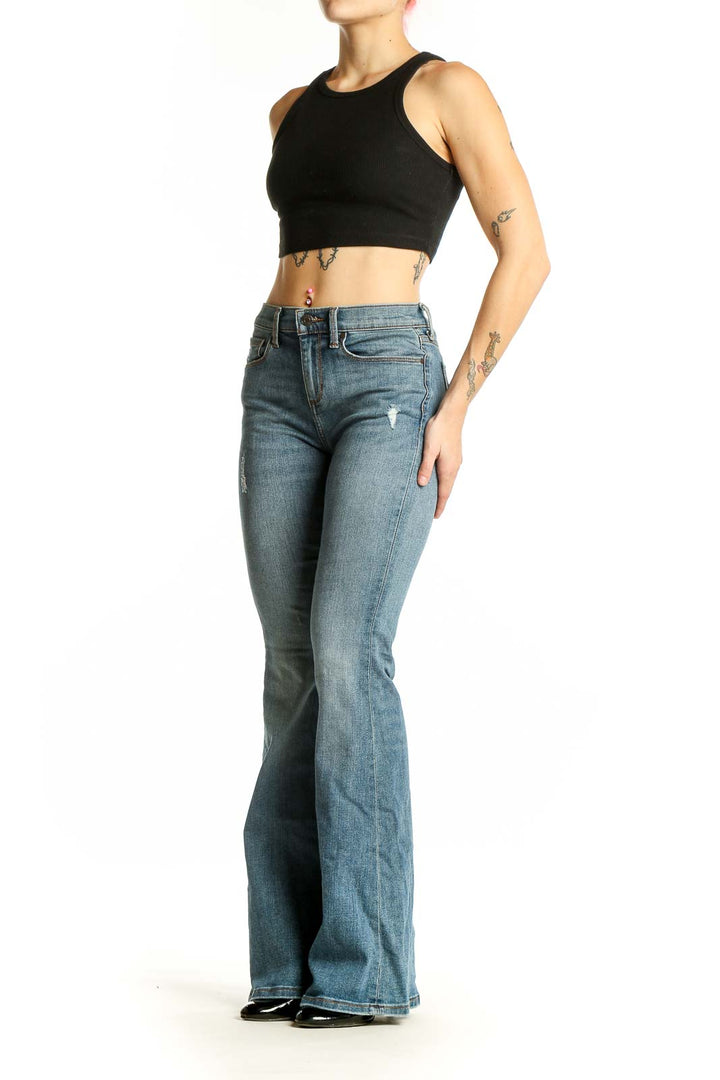 Front view of Banana Republic blue flare jeans with subtle distressing