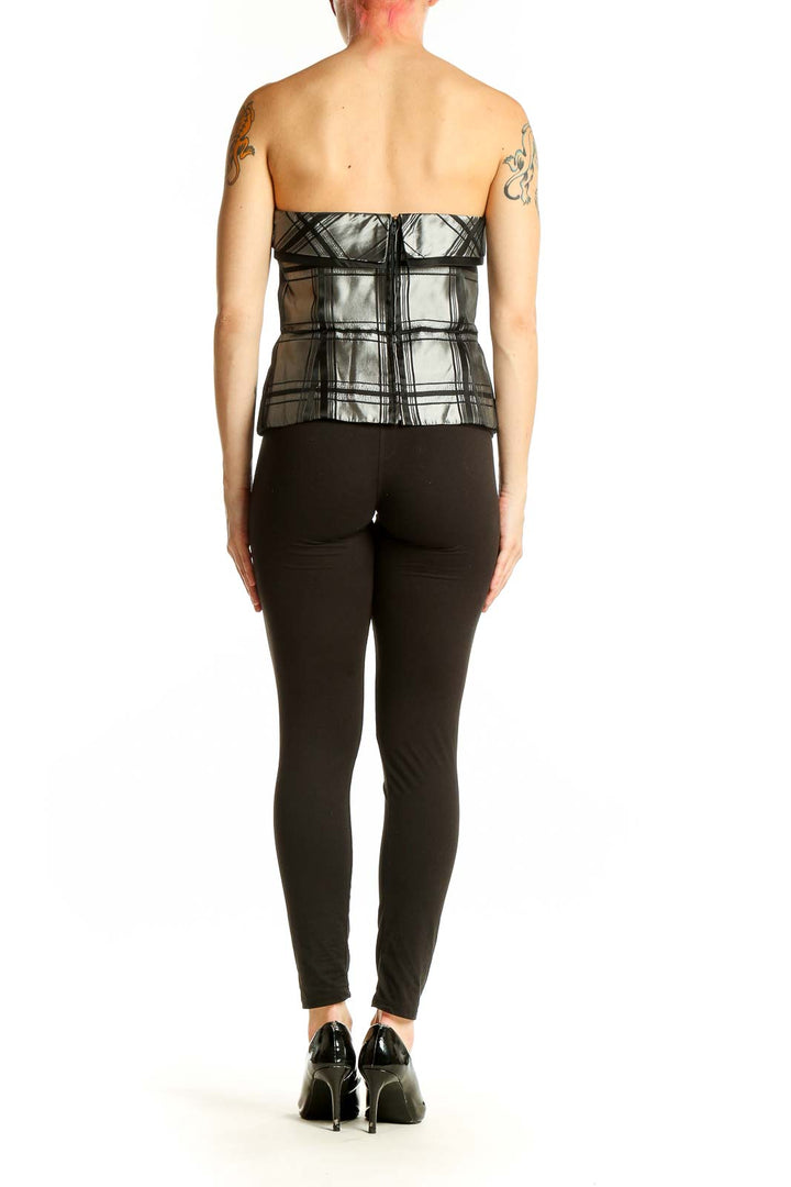 Side view of Silver Metallic Plaid Strapless Top by Michelangelo with black pants