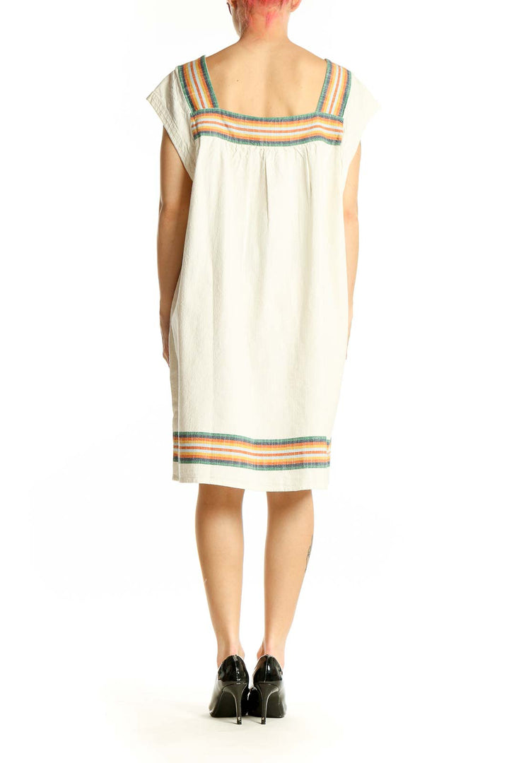 Side view of Faherty cream organic cotton dress showing relaxed silhouette