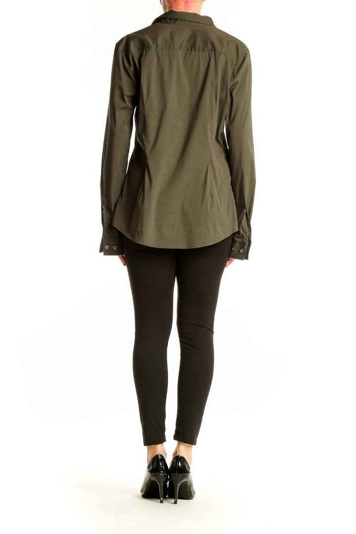 Back view of olive Theory button-down shirt on model with black pants