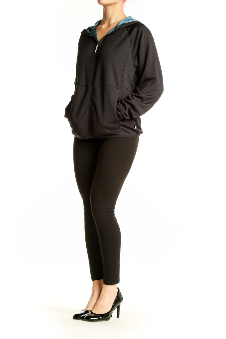 Front view of black Wrangler zip-up activewear hoodie with teal hood lining
