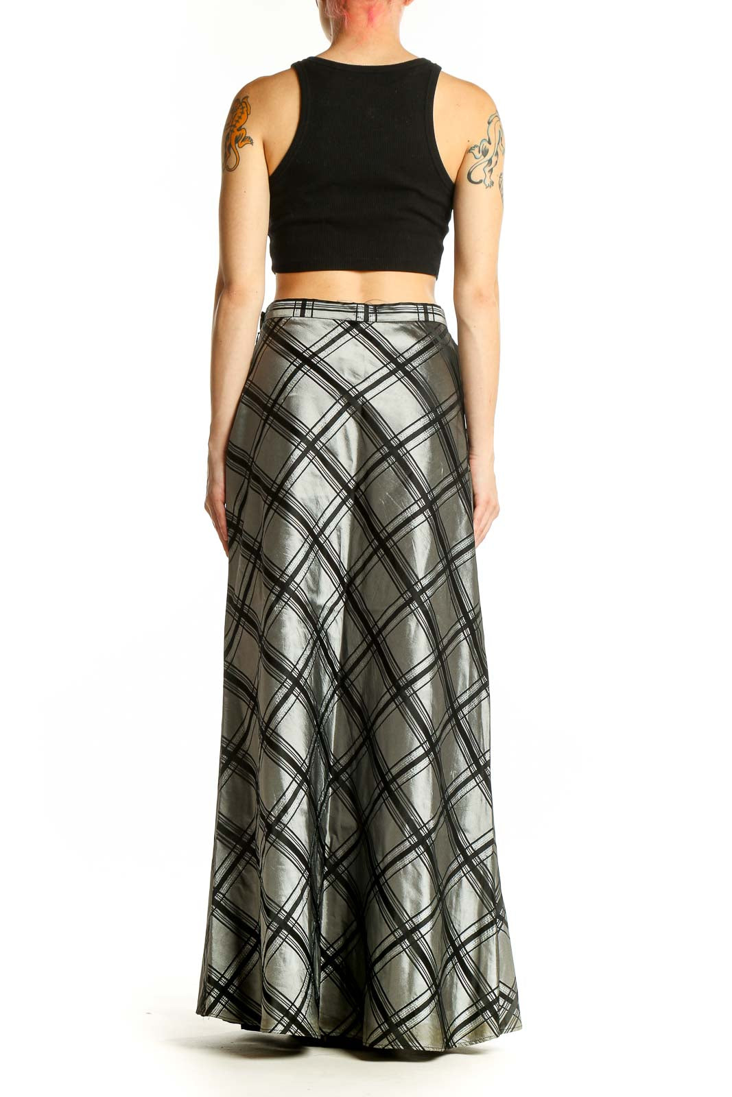 Side view of model wearing Michelangelo silver metallic plaid maxi skirt with black top