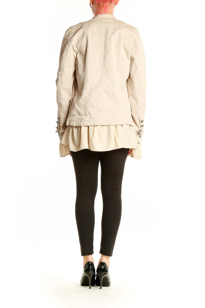 Side view of Free People beige ruffled military-style jacket showing cascading ruffles