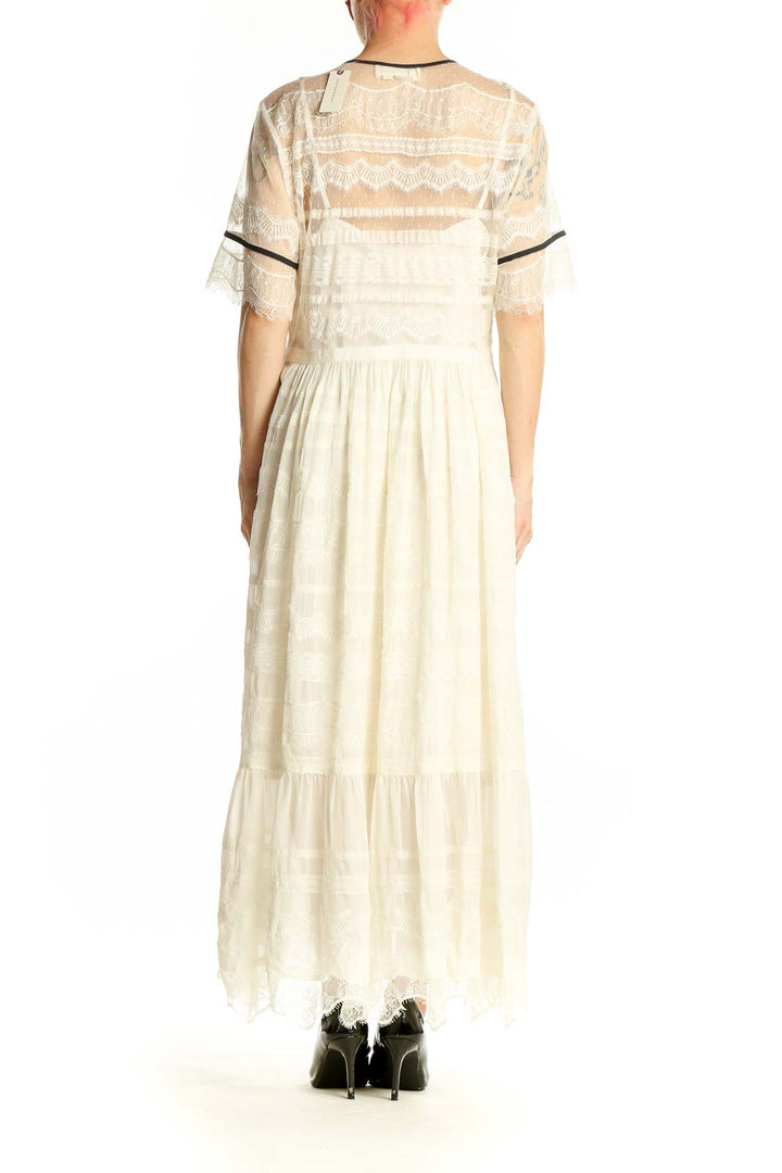 Side view of ivory lace-trimmed maxi dress from Anthropologie