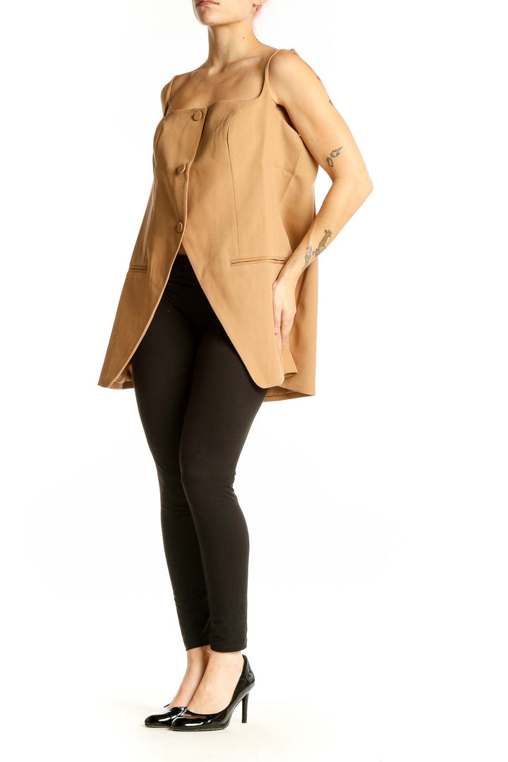 Front view of tan button-front sleeveless top with asymmetrical hemline
