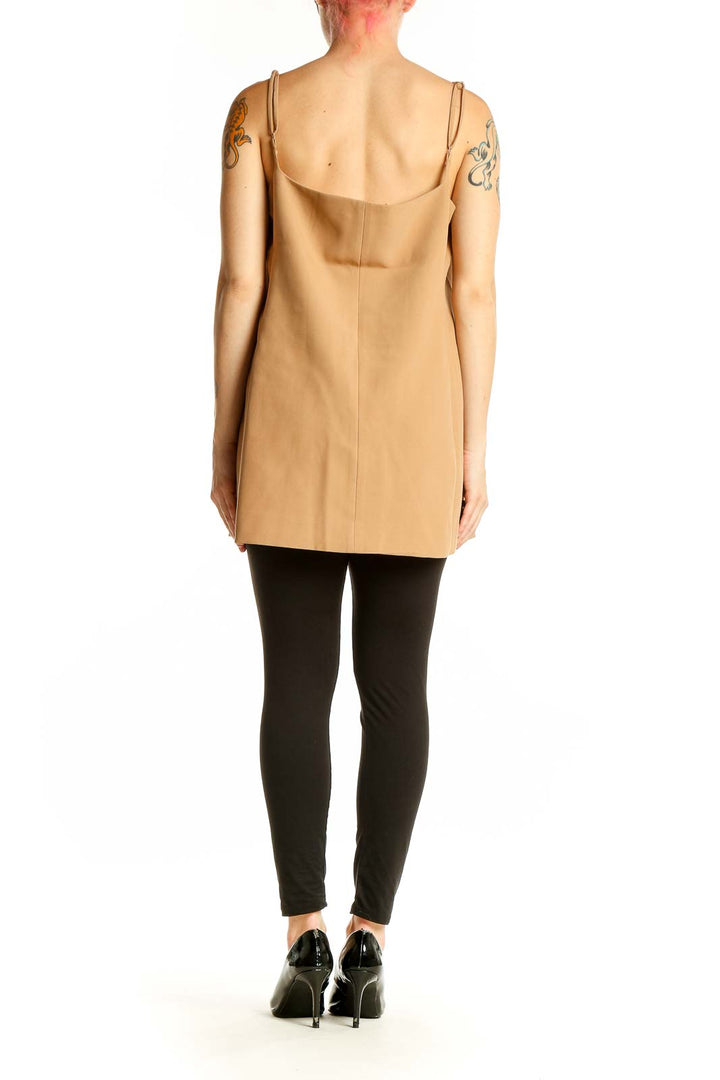 Side view of tan button-front sleeveless top showing asymmetrical design