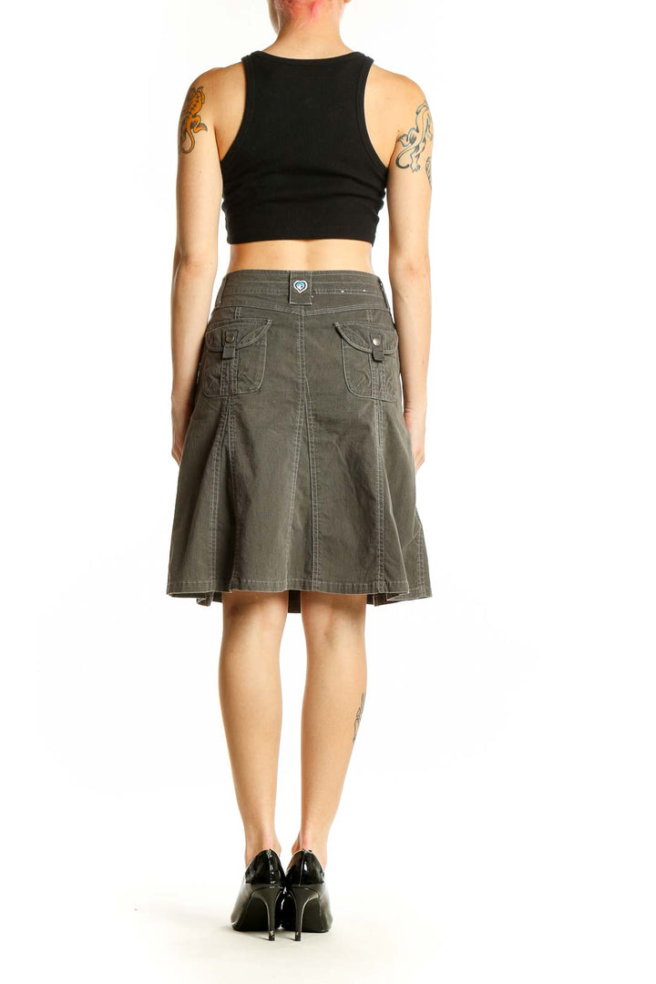 Side view of KUHL olive A-line utility skirt on model