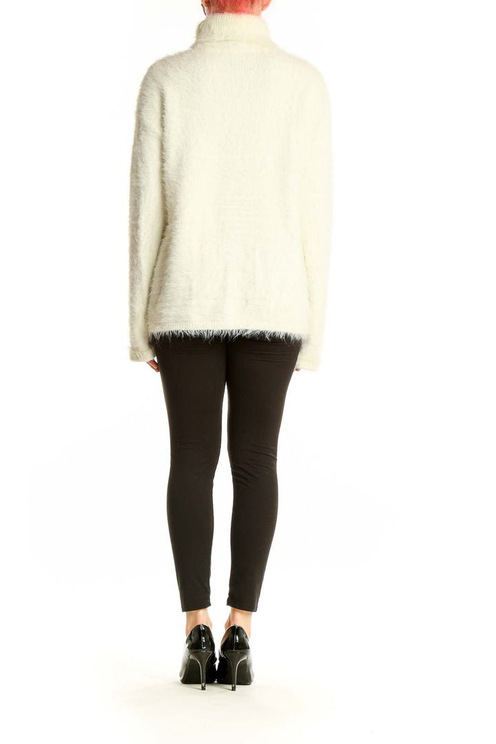 Side view of cream fuzzy turtleneck sweater by Sanctuary on model