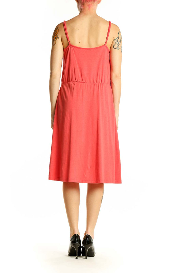 Side view of coral LOFT midi dress showing flowy silhouette and knee-length cut