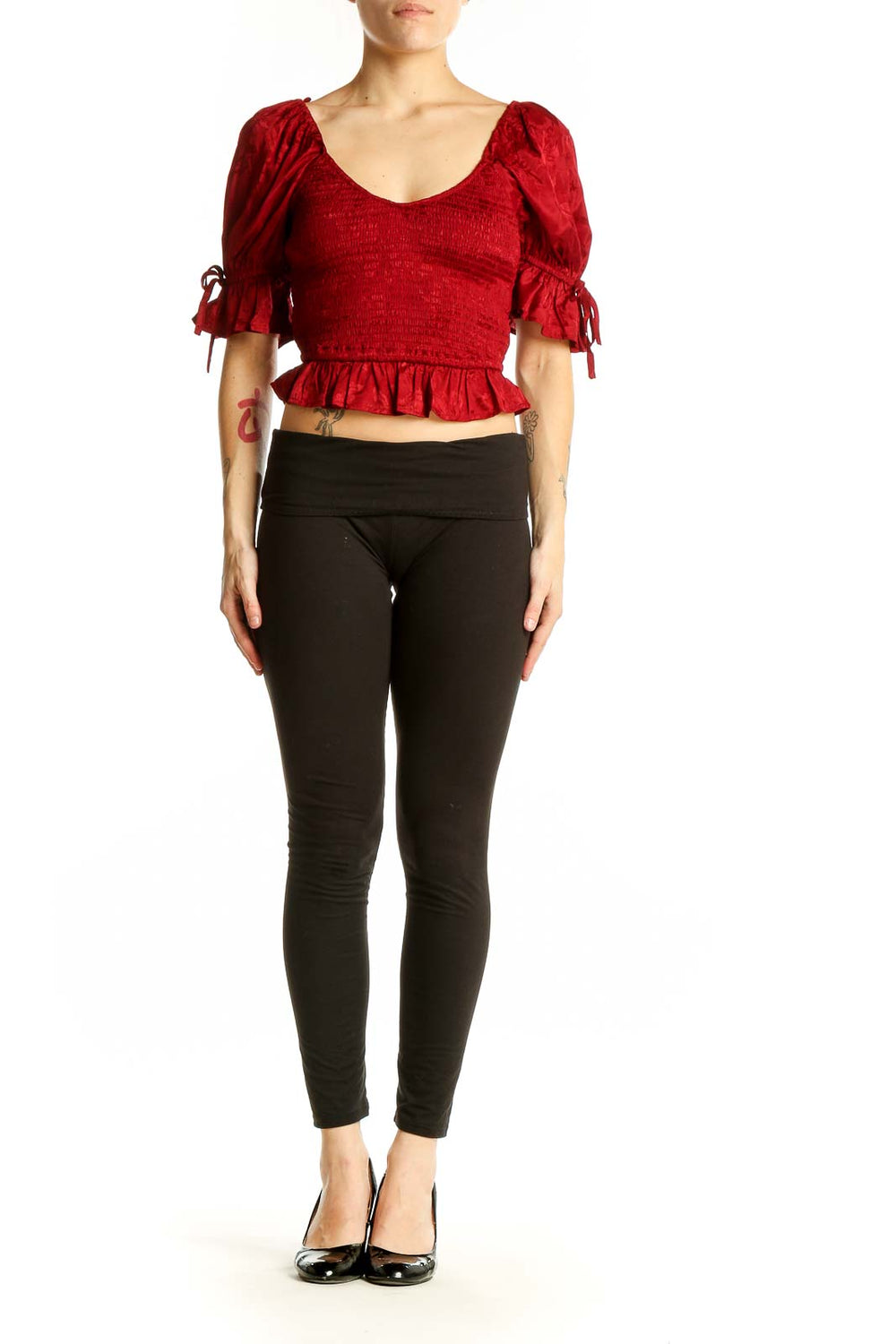 Front view of red smocked crop top with puff sleeves and ruffle hem