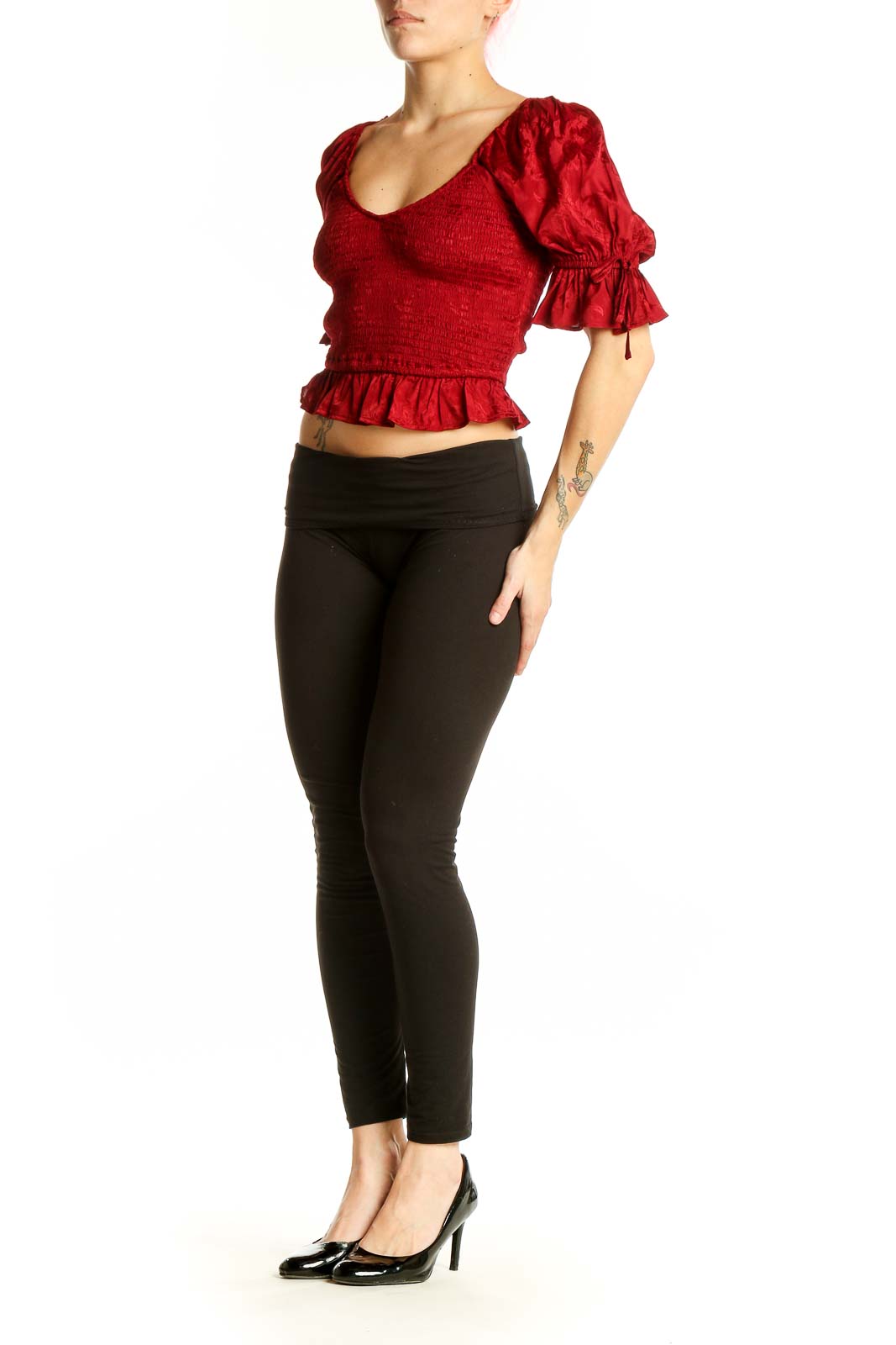Front view of red smocked crop top with puff sleeves and ruffle hem