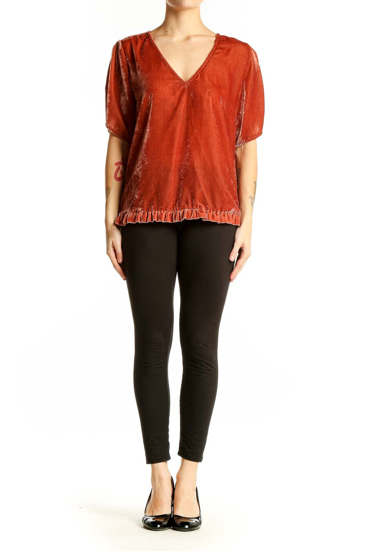 Front view of Madewell rust velvet V-neck blouse with ruffle hem