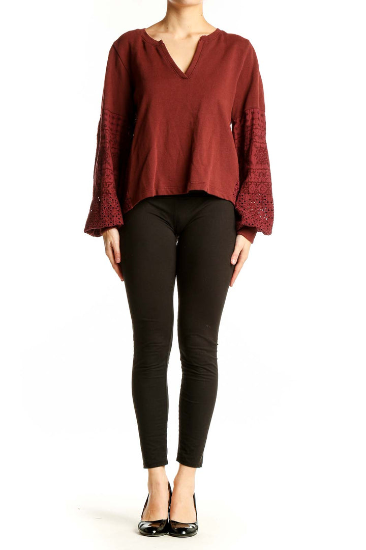 Front view of Anthropologie burgundy knit top with embroidered bell sleeves