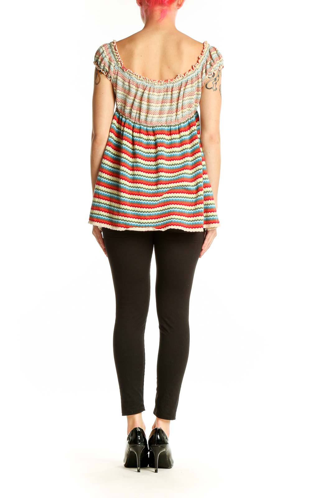 Side view of Free People multicolor striped off-shoulder cotton top on model