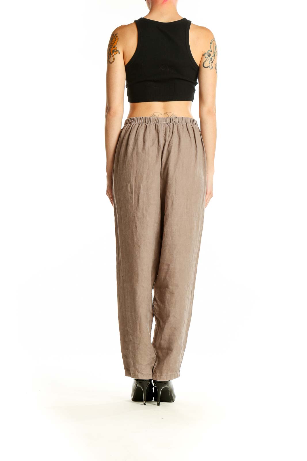 Side view of model wearing beige linen wide-leg pants from Planet