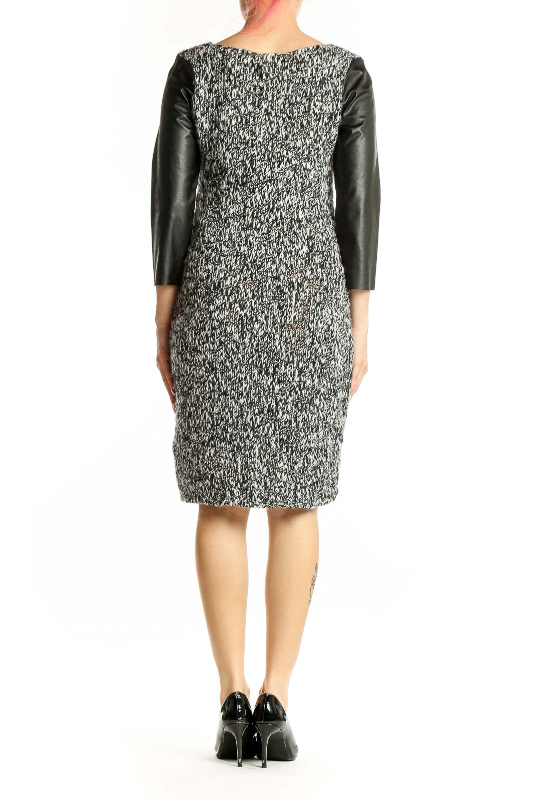 Side view of gray textured Zara Knit dress showing leather sleeve detail