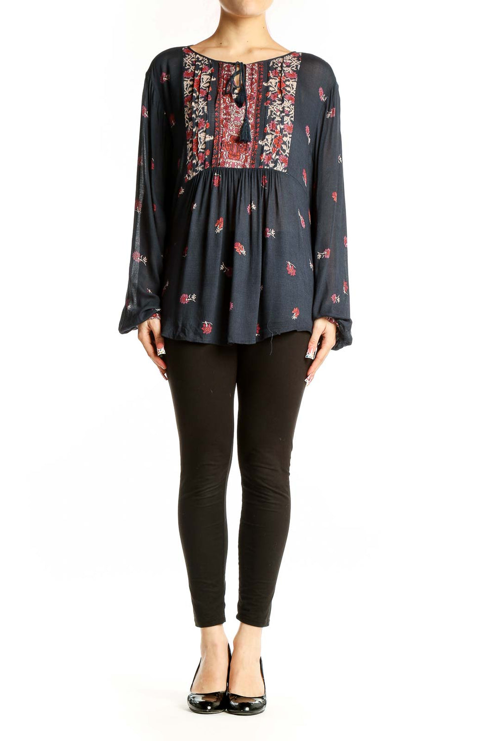 Front view of Lucky Brand black peasant blouse with red floral print and tassel tie