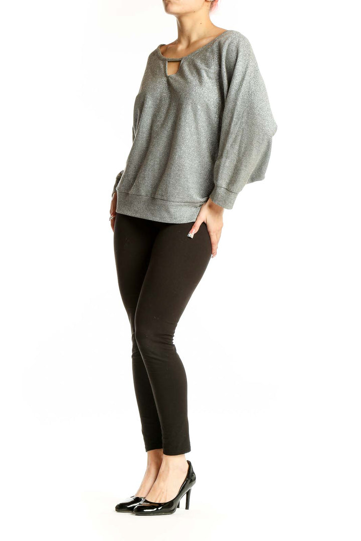 Front view of Guess silver metallic sweatshirt with keyhole neckline