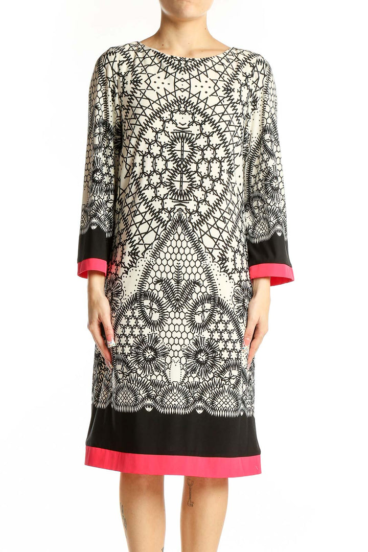 Front view of Eliza J black and white geometric print dress with pink trim