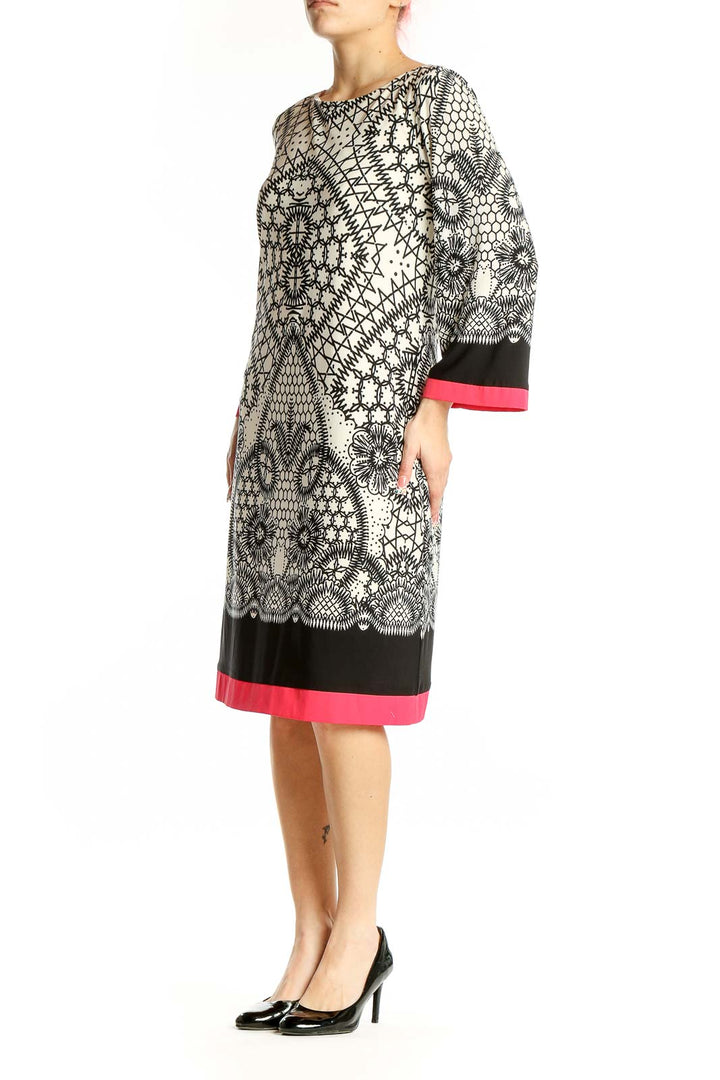 Front view of Eliza J black and white geometric print dress with pink trim