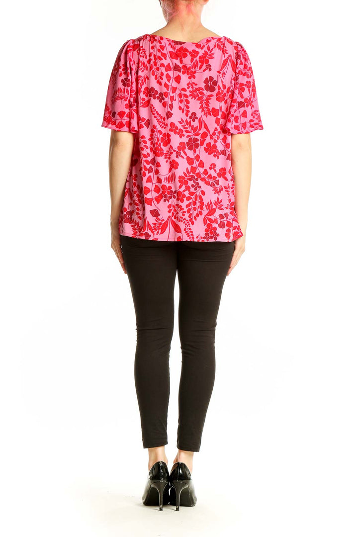 Side view of pink Ann Taylor blouse showing flutter sleeves and floral pattern